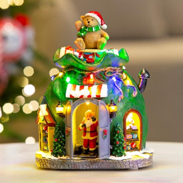VILLA NAVIDEÑA SANTA CLAUS SALIENDO DE BOLSA POLIRESINA CON LUZ Y MÚSICA 22 CM